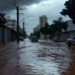 Rua alagada em cidade brasileira por chuvas intensas, com alertas do Inmet para inundações em múltiplas regiões.
