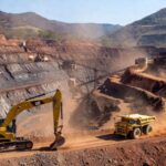 Mina a céu aberto em Minas Gerais com máquinas de mineração, representando acordo para proteção de gestantes contra ruídos.